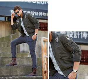 Detail of military style olive jacket with high-quality embroidery badges and ribbed cuffs