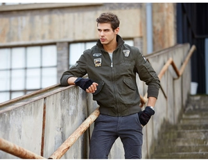 Detailed embroidery patches on army green bomber jacket with military badges and zipper