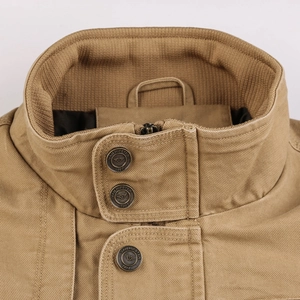 Close-up of khaki cotton utility jacket featuring ribbed inner collar and metal button details
