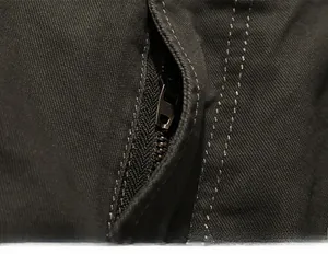 Close-up of durable metal zipper and heavy-duty stitching on green cargo pants