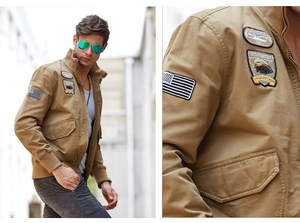 Close-up of military badges and cargo pockets on khaki cotton tactical jacket for men