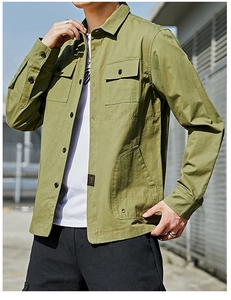 Detail of army green utility shirt jacket with chest pockets and twill cotton texture
