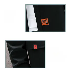 Detail of khaki casual shirt featuring orange DESIGN label and red woven cuff tag