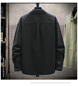 Close-up of the black long-sleeved shirt featuring back box pleat detail and crisp cotton fabric