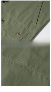 Detail view of olive green cargo jacket with high-density canvas stitching and side pockets