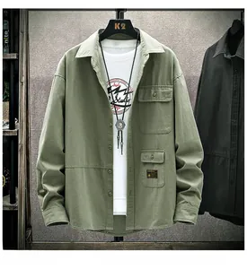 Detailed view of the double chest pockets and black logo on olive green work shirt