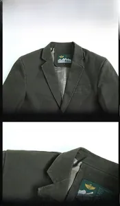 Detailed close-up of dark green cotton twill blazer lapel and shoulder stitching details