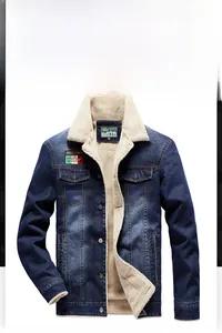 Detailed view of dark blue denim jacket with warm white fleece lining and chest patches