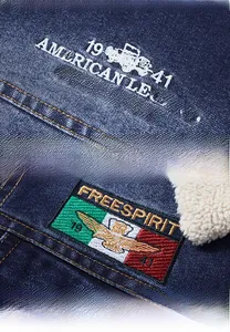 Close-up of vintage American Legend embroidery and jeep graphic on dark blue denim jacket