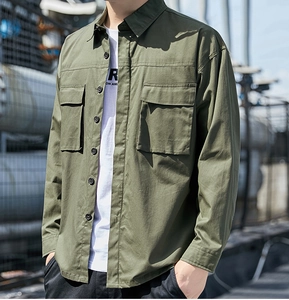 Detail of army green cargo shirt with chest pockets and buttons for men's outdoor wear