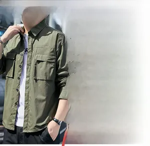 Detail of army green long sleeve shirt featuring dual chest flap pockets and black buttons