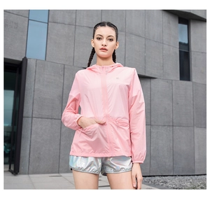 Detail of pink hooded sun protection jacket featuring elastic cuffs and side pockets