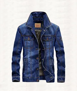 Detail of light blue heavy washed denim jacket with metal buttons and chest pockets