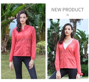 Detail of red lightweight hooded sun protection jacket with zip pockets and breathable fabric