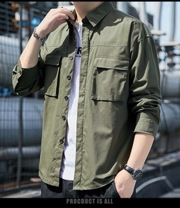 Detail of military green cotton cargo shirt featuring large flap chest pockets and buttons