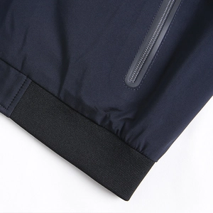 Men's reversible navy casual jacket featuring ribbed hem and waterproof zipper pocket detail
