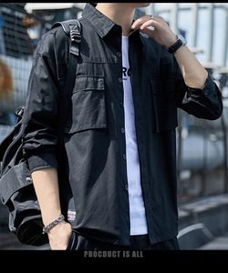 Detail of men's black cargo shirt featuring dual chest pockets and durable cotton fabric