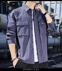 Detail of men's casual long sleeve shirt featuring dual flap pockets and classic collar