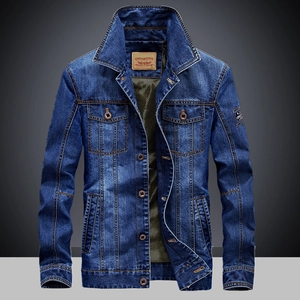 Detail of dark blue denim jacket with vintage wash effects and branded leather neck label