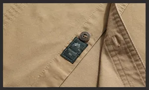 Detail view of cotton outdoor shirt with outdoor 1961 patch and fashion engraved button
