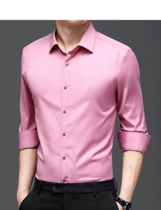 Detail of slim fit dusty pink business shirt showing micro-texture and roll-up sleeves