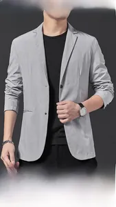 Detail of light gray casual men's blazer featuring fine polka dot texture and lapel