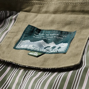 Army green military style jacket with premium mountain label and striped lining detail