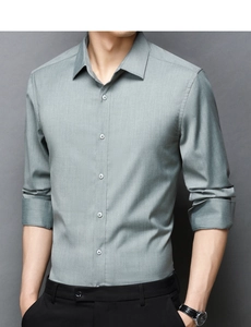 Detailed view of gray-green slim fit business shirt fabric texture and white buttons