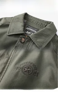 Detailed view of cargo jacket collar with brand label and star embroidery on cotton fabric