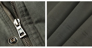 Macro shot of bronze metal zipper and reinforced double stitching on the olive green jacket