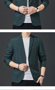 Detail of slim-fit dark green blazer with white micro-dot texture and classic notch lapels