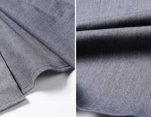 Detail shot of grey twill fabric texture and fine stitching on men's slim fit shirt