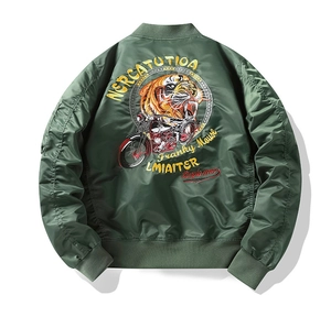 Detail of tiger and vintage motorcycle embroidery on back of green MA-1 flight jacket