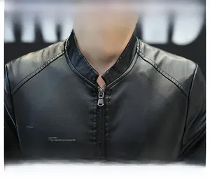 Detailed close-up of men's leather jacket collar featuring premium lychee grain texture