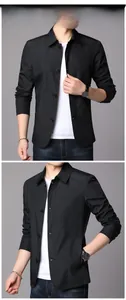 Detail view of black men's jacket showing slim lapel and textured fabric surface