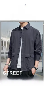 Detail of dark grey long-sleeved cargo shirt with large flap pockets and classic collar