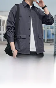 Detailed view of the dark grey workwear shirt featuring large double chest utility pockets