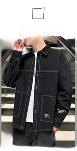 Detail of black street style shirt showing white contrast stitching and utility pockets