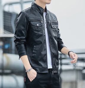 Close-up of black biker jacket with multi-pocket details and metallic zipper accents