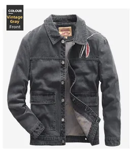 Detail of vintage grey denim jacket featuring dual-color feather embroidery and metal buttons