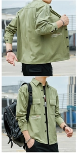 Detail of olive green cargo shirt with white graphic print and front flap pockets