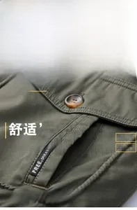 Detail of olive green twill jacket fabric featuring durable buttons and Free Spirit tape