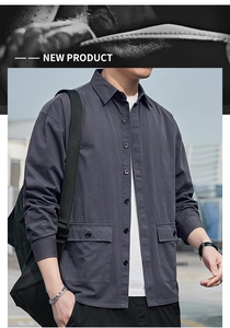 Close-up of grey long sleeve utility shirt with large flap pockets and button-down front