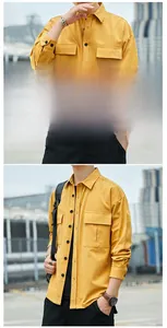 Detail view of yellow cotton cargo shirt featuring dual chest pockets and black buttons