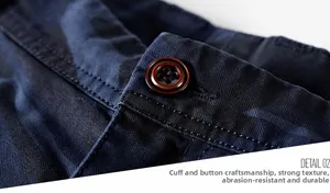 Detail of sleeve cuff with brown button on navy camouflage twill cotton shorts