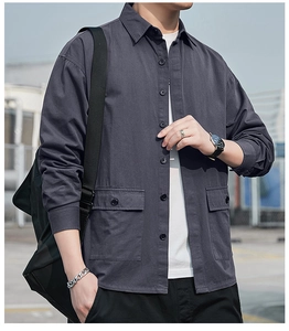 Detail of dark grey long sleeve shirt with front utility flap pockets and button-down collar