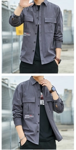 Close-up of gray cotton work shirt featuring dual flap pockets and white letter printing