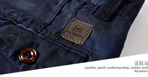 Macro detail of men's shorts waist featuring a brown leather patch and branded button