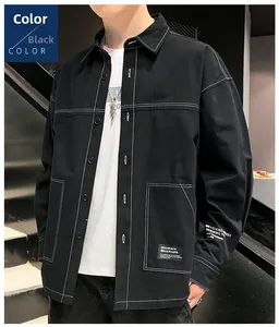 Detail of black workwear shirt jacket with white contrast stitching and graphic pocket print