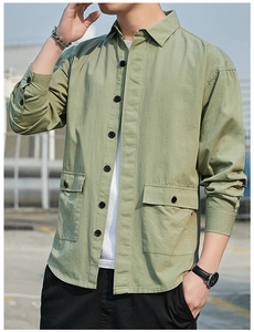 Detail of olive green cargo shirt featuring large symmetric chest pockets and black buttons